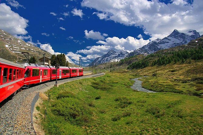 From Lake Como or Milan: Bernina Red Train Tour - Tirano station and the Bernina Red Train in first class